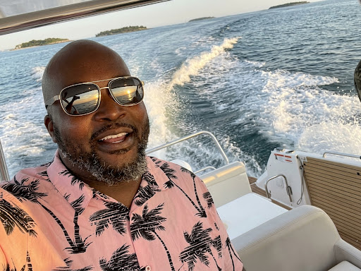 Captain Chris, co-host of Baddies Only Yacht Club, on a boat