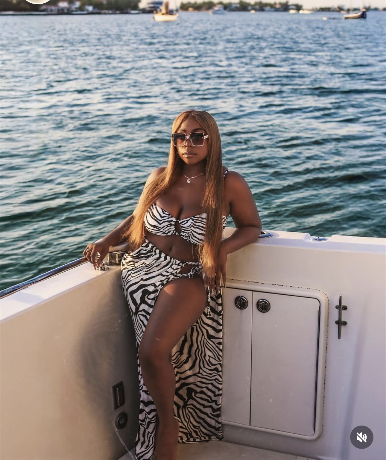 Keke Nova in a zebra-print two-piece and sunglasses on a yacht